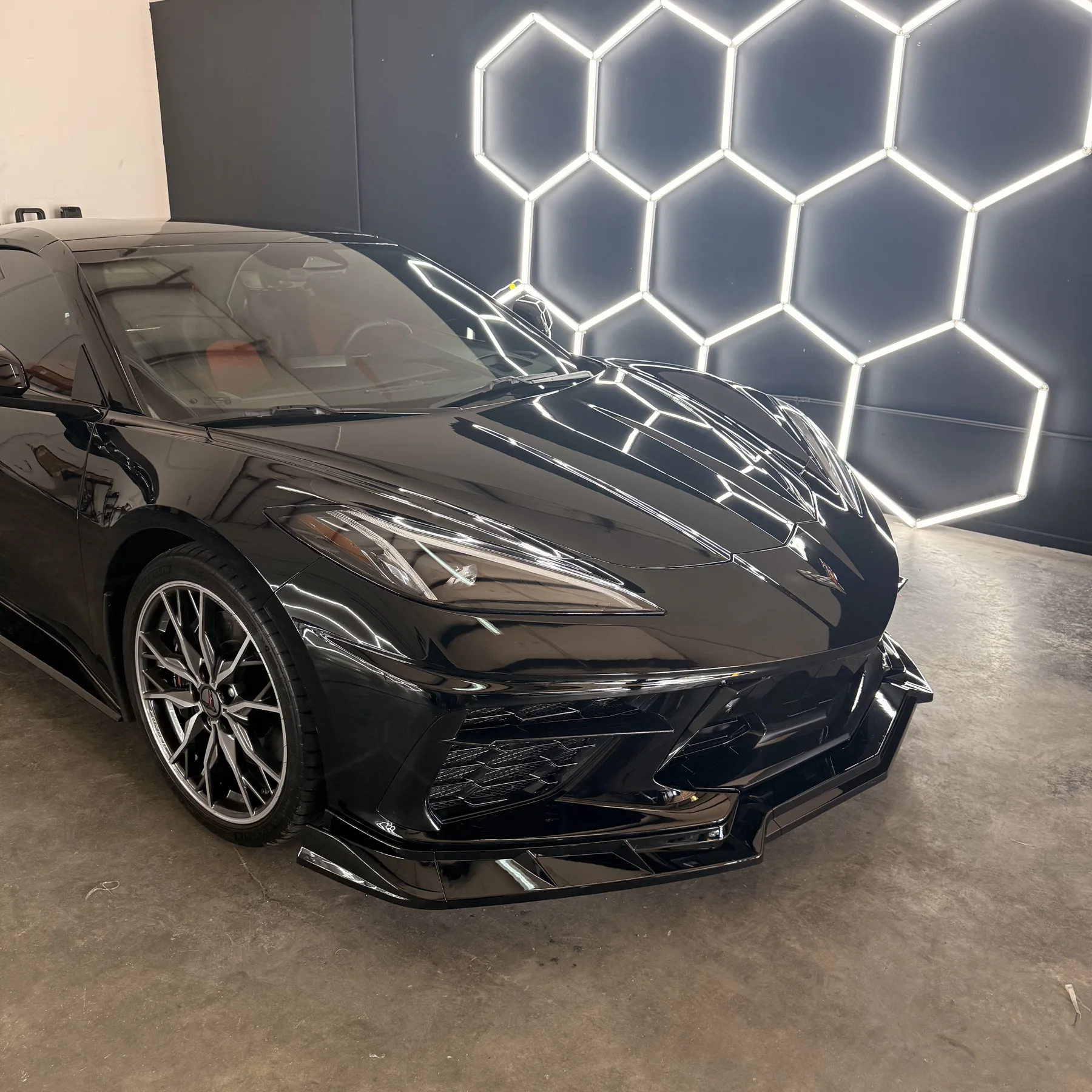 Black Chevrolet Corvette showcased in the Tekta Auto Care studio