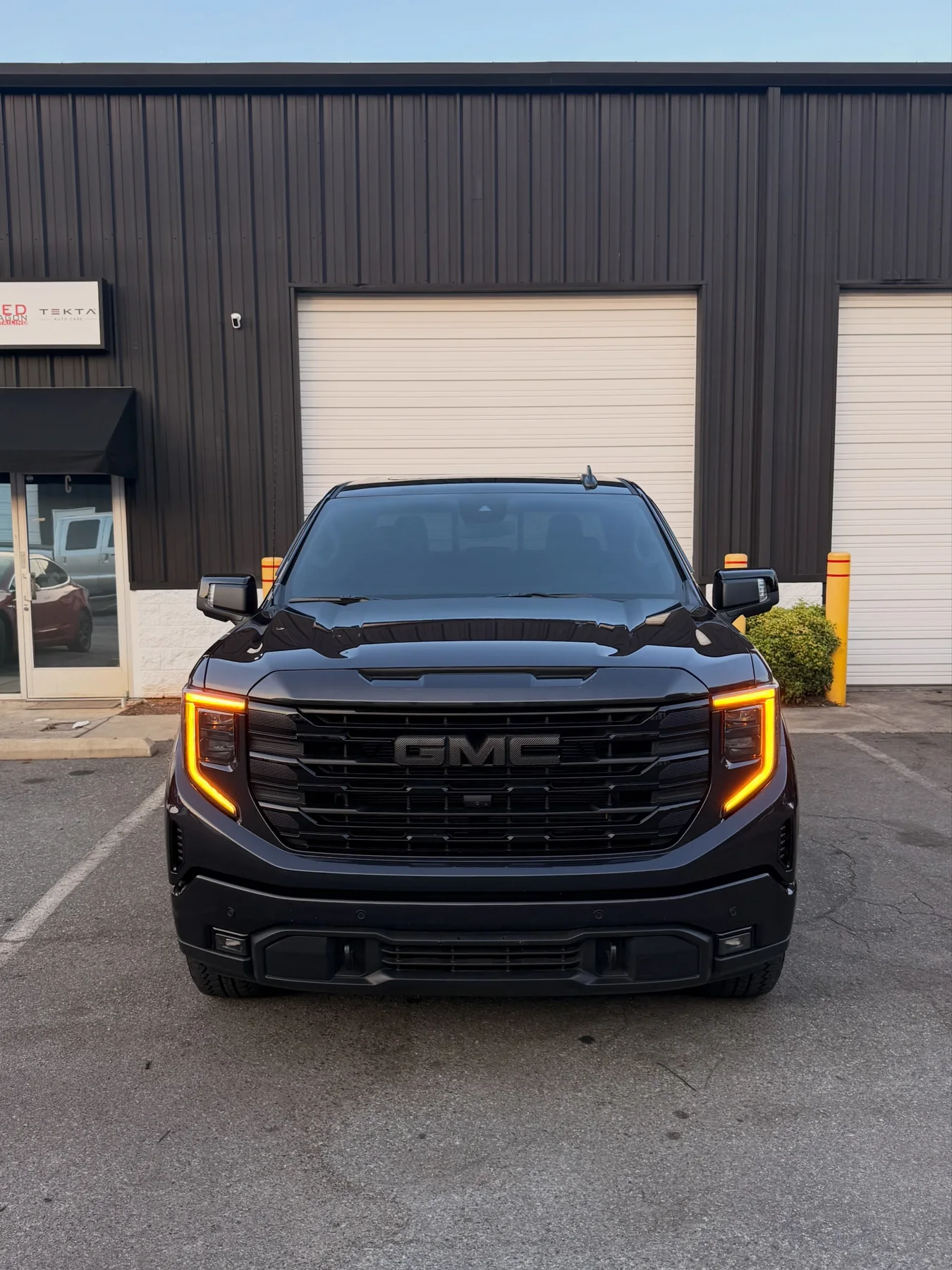 Black GMC Sierra with a freshly detailed finish outside Tekta Auto Care